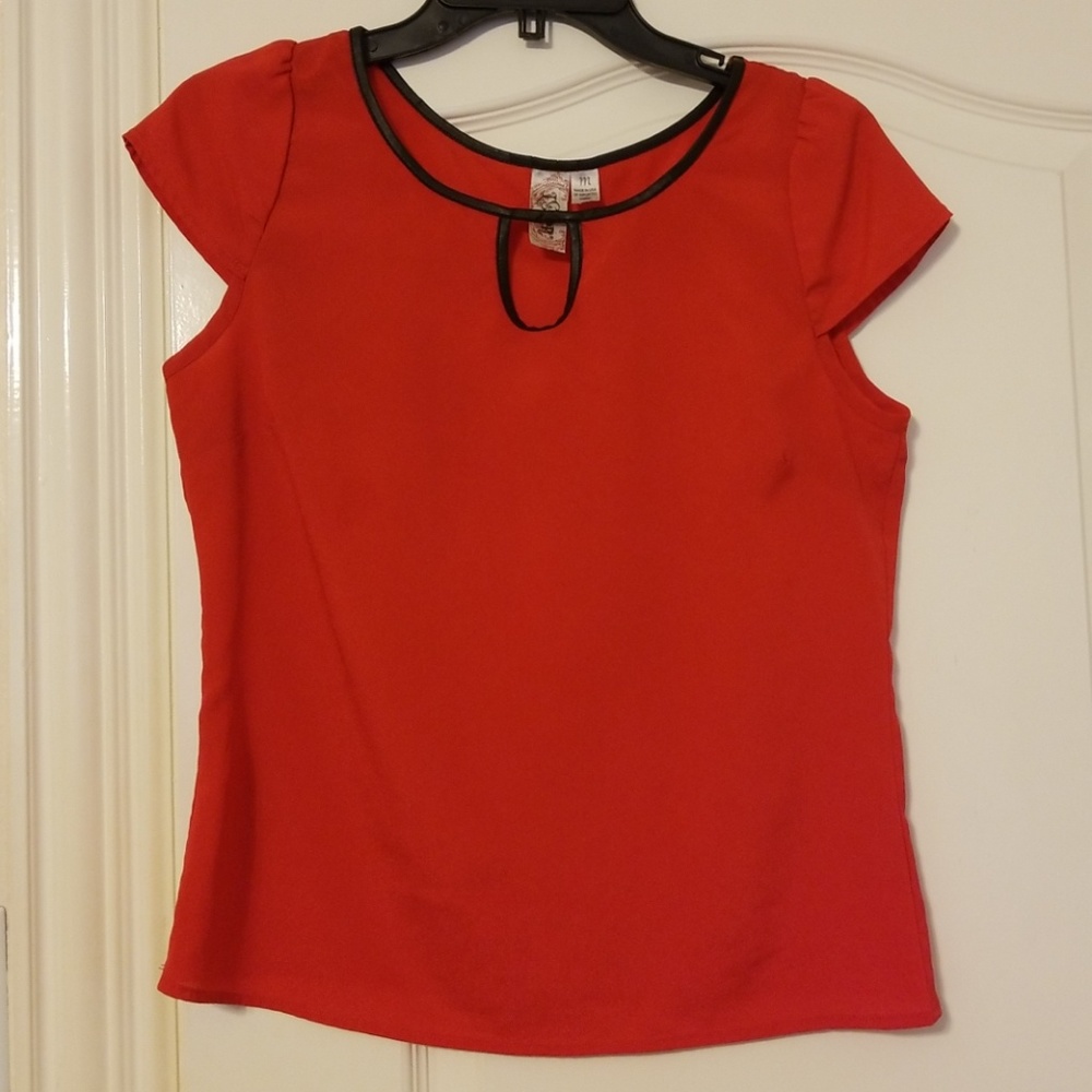 Bright red blouse with black trim